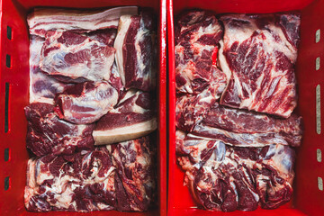 closeup shot of pieces of fresh beef in red baskets, butchers shop. High quality photo