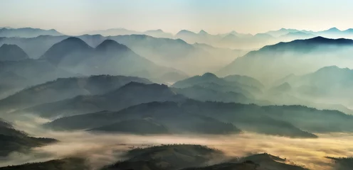 Fototapeten silhouettes of morning mountains. foggy morning in the Carpathians. Mountain landscape © sergnester
