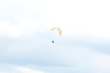 Paragliding in the Chicamocha Canyon area, in Santander, Colombia. A paraglider in the sky, flying in the middle of the clouds.