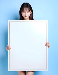A beautiful and cute girl holding a blank message board with nothing written on it. with copyspace