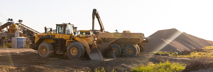 Heavy equipment works at a sand processing quarry