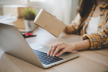 Efficiently preparing packages for seamless shipping. The hands of an online store meticulously...
