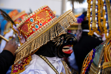 Dancers in traditional costumes at the festivity of the Virgen del Carmen, Paucartambo square,...