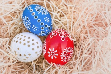Colorful easter eggs in a nest of straw. Easter background