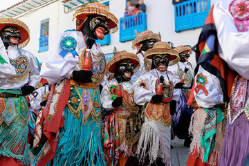 Dancers in traditional costumes at the festivity of the Virgen del Carmen, Paucartambo square,...