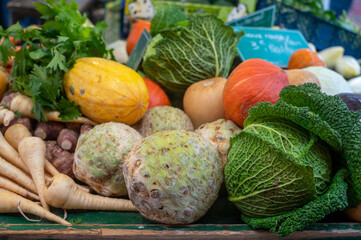 Farmers outdoor market with seasonal winter organic raw root vegetables, pumpkins, cool, carrots