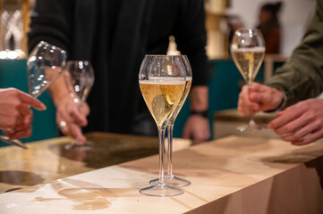 Tasting of sparkling wine champagne on winter weekend festival in December on Avenue de Champagne,...