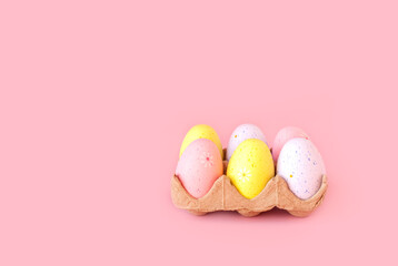 Eco basket with colorful easter eggs on pastel light pink background. minimalistic decoration,...