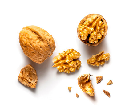 one whole and one open walnut isolated on white background
