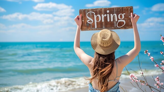 Spring concept image with a young woman at the beach for spring and sign