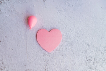 Pink heart sticky note on pink background with copy space 