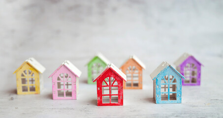 Real estate market concept with colorful wooden houses figurines