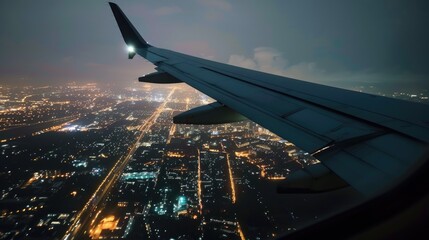 Plane wing, view from plane window with with the city light