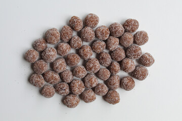 Tamarind candy, small ball shaped. On white background, flat lay or top view