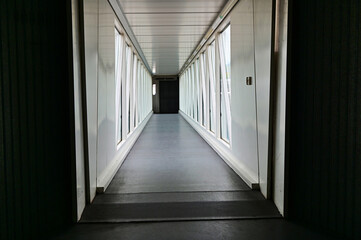 interior view of deserted closed boarding bridge corridor to the airplane