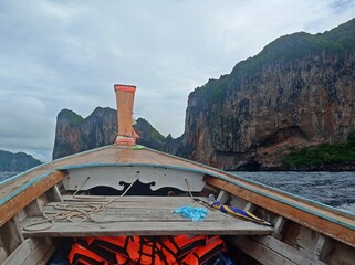 wooden motor boat in sea at Phi Phi Island