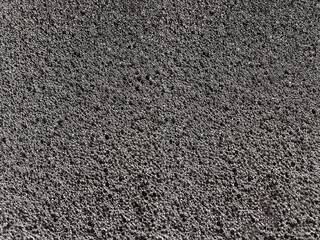 black sponge foam material surface background. textured absorbent material and coarse pores