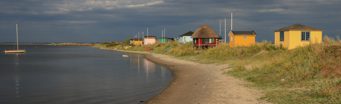 Colorful tiny beach huts at Eriks Hale in Marstal on the Danish island of &AElig;r&oslash;.	