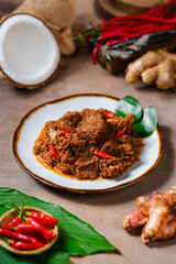 Rendang Pork. Rendang is an Indonesian West Sumatra Minangkabau spicy meat. that slow cooked in...