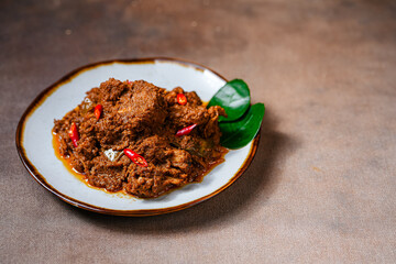 Rendang Pork. Rendang is an Indonesian West Sumatra Minangkabau spicy meat. that slow cooked in coconut milk and mixed spices.