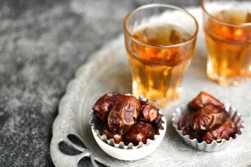 Kurma  or Dried Dates and hot tea on silver tray. 