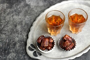 Kurma  or Dried Dates and hot tea on silver tray. 