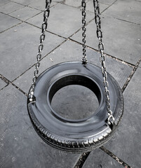 tire swing on metal chains in a public park (mount prospect park brooklyn new york city) urban...