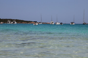 Yachts and catamarans in Cala Brandinchi Beach in San Teodoro, Sardinia, Italy