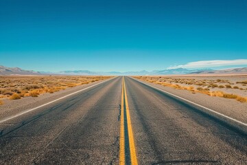Fototapeta na wymiar Desert road adventure Featuring an empty asphalt road stretching into the horizon under a clear sky Evoking freedom and exploration