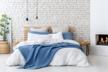 Bed with blue pillows and coverlet near fireplace against white brick wall Loft scandinavian interior design of modern bedroom