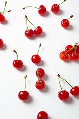 ripe red cherries close up on light surface