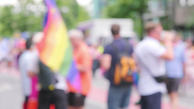 blurred march LGBTQ community, mass march of lesbian, gay people, bisexual, transgender with rainbow flags, Gay pride parade in city with rainbow flags, against discrimination on queer people