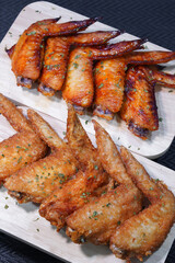 Grilled chicken wings on a wooden board.