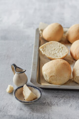 Appetizing fresh rolls on a tray and light gray background, homemade breakfast/meal concept, healthy food, close-up, minimalist ,wheat flour bread.
