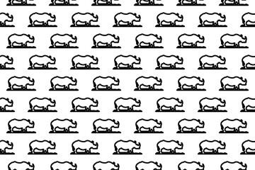 Seamless pattern completely filled with outlines of wild rhino symbols. Elements are evenly spaced. Illustration on transparent background