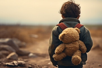Back view photo of small kid refugee with teddy bear looking on ruined city generative ai