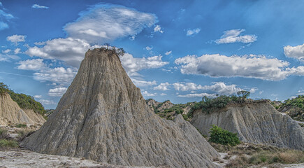 view of Aliano badlands (calanchi), landscape made of clay sculptures eroded by the rainwater, Basilicata region, southern Italy - obrazy, fototapety, plakaty