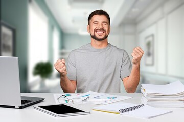 Man sit and work on laptop feels happy. victory concept