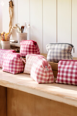 Cosmetic pouches in various sizes featuring gingham patterns сreated with Generative Ai