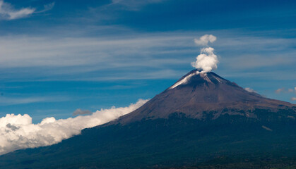 Majestic slumber: A serene yet potent volcano breathes against the backdrop of a tranquil sky.