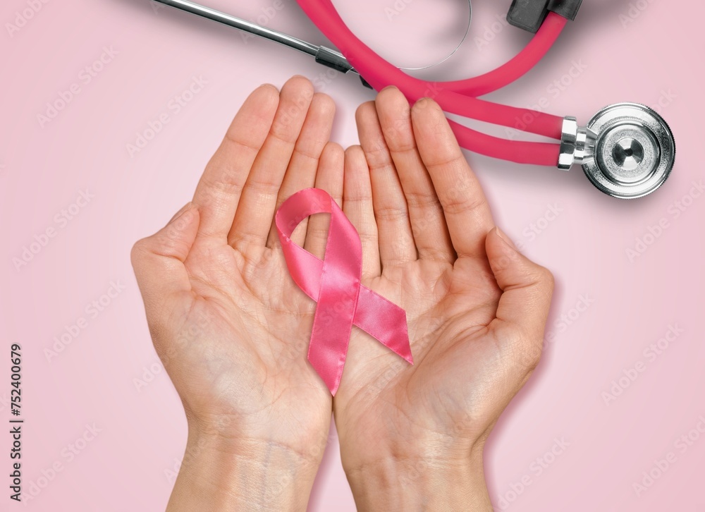 Wall mural Breast Cancer Month with hand holding ribbon