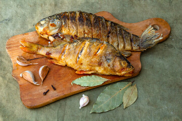 Fried appetizing fish on barbecue, picnic food close-up