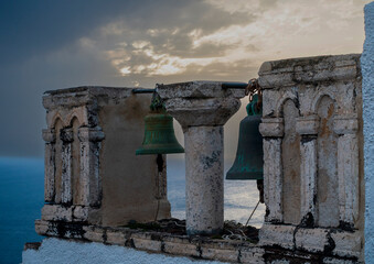 Sunset view of ancient bells at greek monastery, copy space. © Raquel