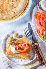 Pancakes with gravlax, cottage cheese and olives. A traditional dish for Maslenitsa or Carnival. - 752402273
