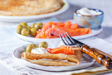 Pancakes with gravlax, cottage cheese and olives. A traditional dish for Maslenitsa or Carnival. - 752402472