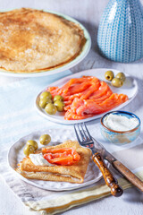 Pancakes with gravlax, cottage cheese and olives. A traditional dish for Maslenitsa or Carnival. - 752402681