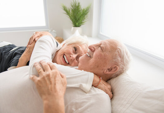 Senior 80 years old Couple Relaxing In Bed together - Powered by Adobe