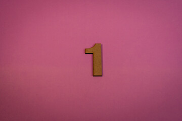 Number one in wood on pink background