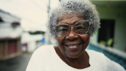 Portrait of Joyful 80s African Descent Senior Woman with Gray Hair on Balcony, close-up of South...