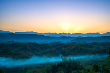 In the early morning, the sun rises from behind the mountains. The Erliao tribe in Zuozhen enjoys...